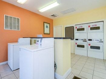 Four washers and dryers in a laundry room